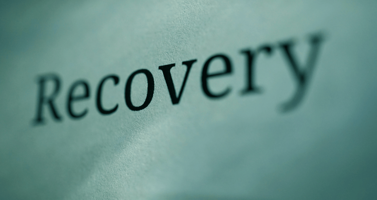 The word recovery written on a blank sheet of paper